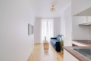 A modern kitchen with a wooden countertop and a stainless steel sink. - Charming apartment 1BR/3P - Oberkampf (Paris)