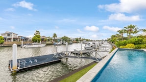 A marina with boats docked, a swimming pool, and houses in the background. - Tranquillit, TOP NOTCH (BANKSIA BEACH)