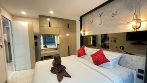 A modern hotel room with a large bed, a mirror, a television, and a bathroom visible through an open door. - A201 - 1 Bedroom 1 Bathroom with private bubble Jacuzzi, garden at Ao Nang Beach (Tambon Ao Nang)