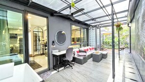 A modern interior with a glass ceiling, a kitchen area, a seating area with a sofa and chairs, and a large mirror on the wall. - A201 - 1 Bedroom 1 Bathroom with private bubble Jacuzzi, garden at Ao Nang Beach (Tambon Ao Nang)