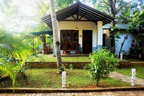 A small, single-story building with a sloped roof and a porch area. - Danu Resort (Inamaluwa)