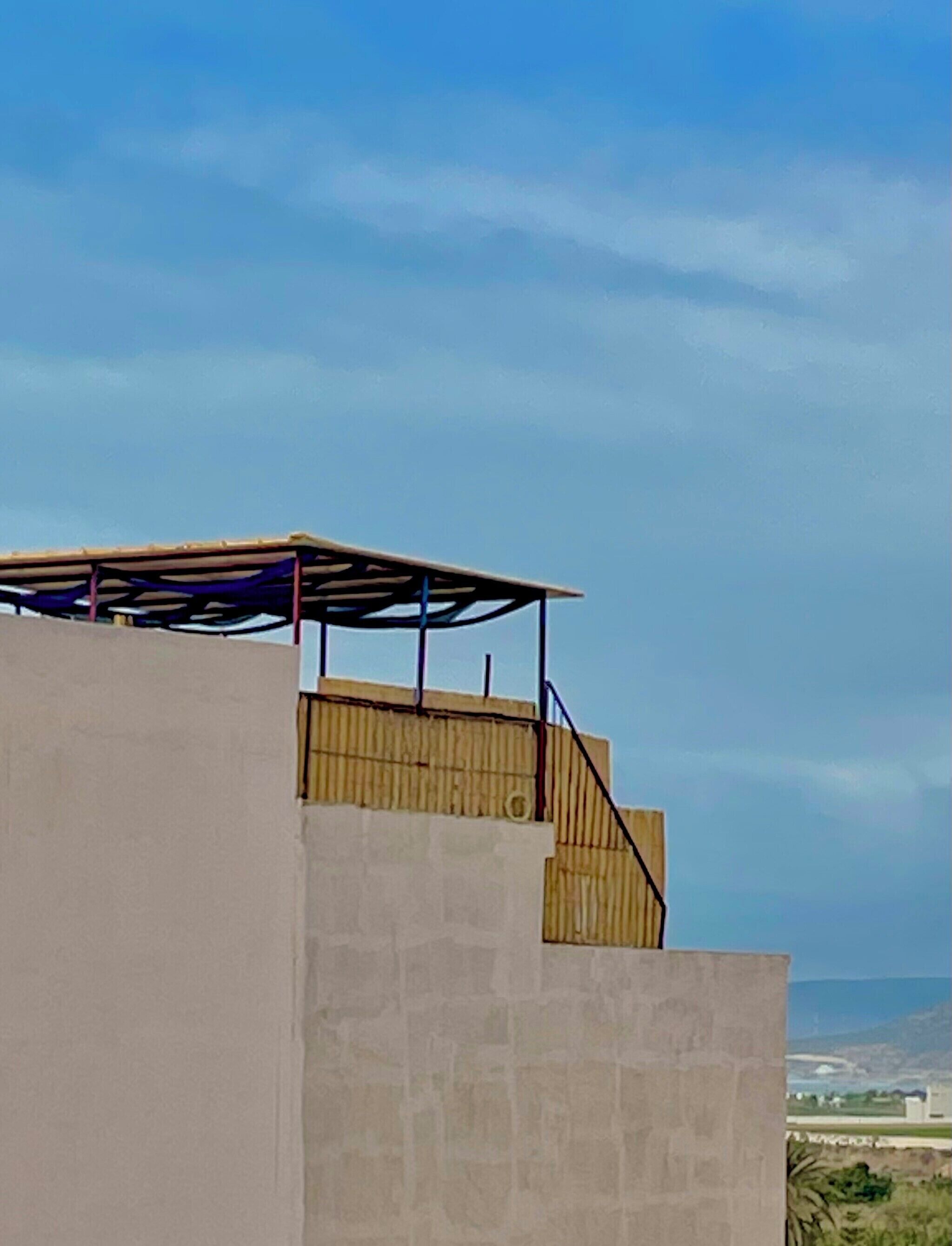 A construction site with a partially built structure, including a concrete wall and a wooden framework.