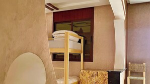 A room with bunk beds, a small desk, and a chair. - tayri surf house (Aourir)