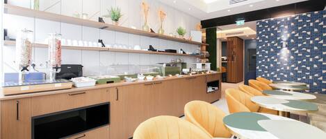 A modern restaurant with wooden counters, yellow chairs, and a patterned wall.