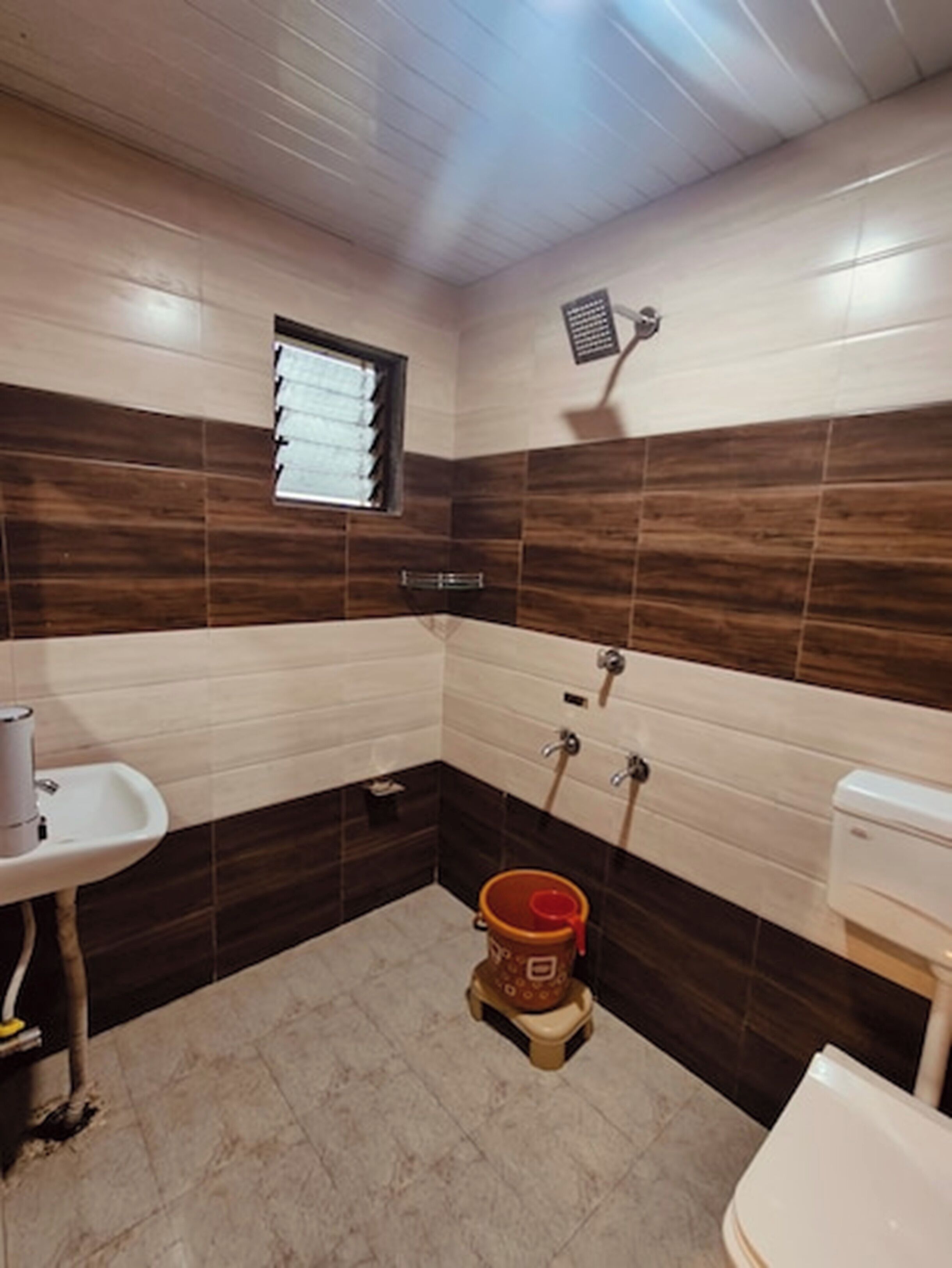 A bathroom with a sink, toilet, and shower.