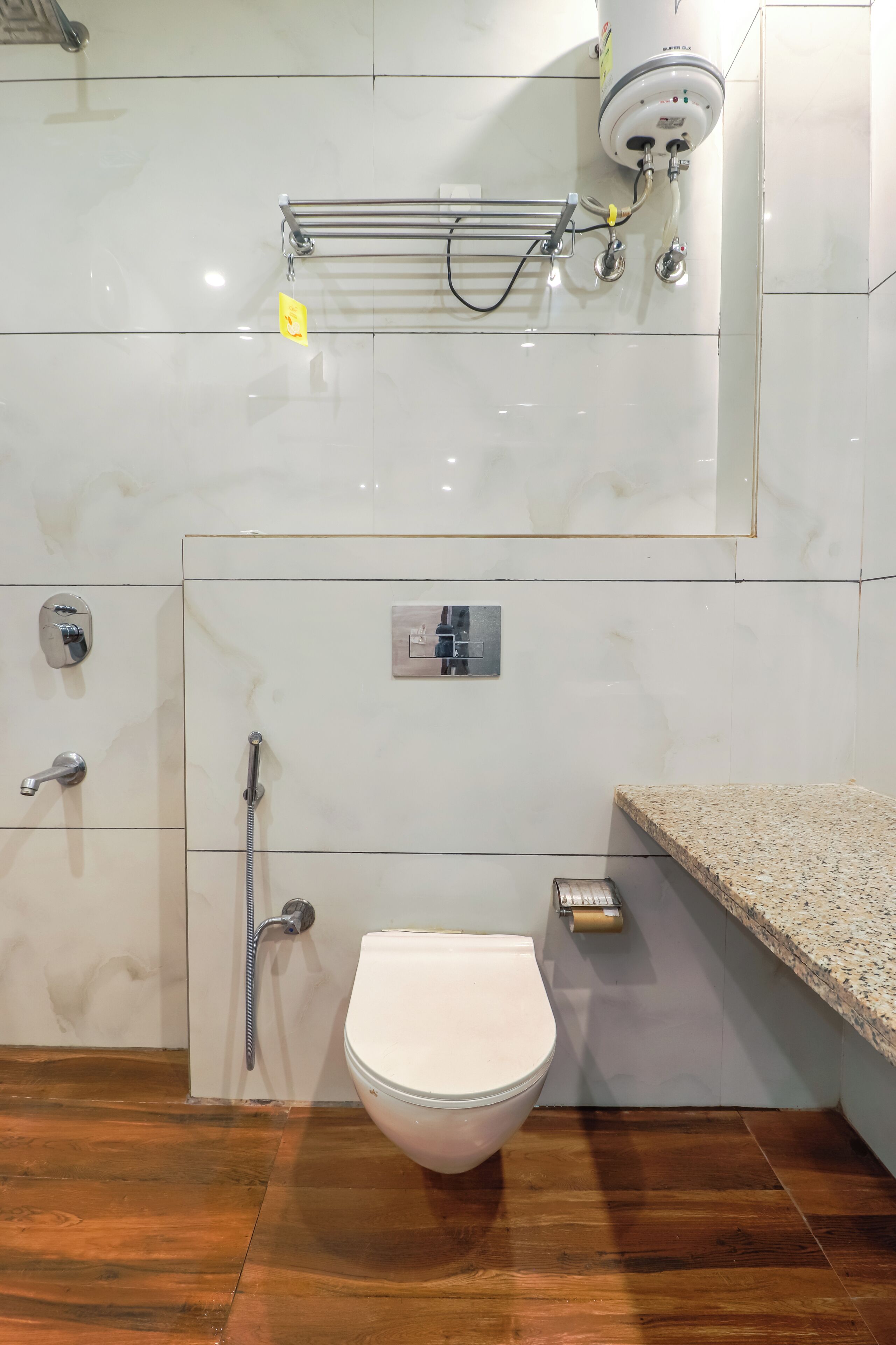 A bathroom with a toilet, a shower, and a sink.