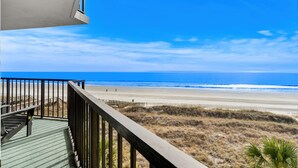 A balcony with a view of a beach and ocean. - 10% off weekly stays (Sat-Sat) thru Aug. 3BR 3BA OF condo. Crescent Beach. (North Myrtle Beach)