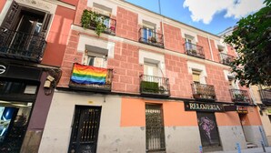 A building with a storefront named "RELOJERIA" and a rainbow flag hanging outside. - (SVF1304) Cozy Studio in the Center of Madrid (Madrid)