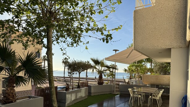 A patio area with a view of the sea, outdoor furniture, and a covered seating area. - Home 65F - Beachfront with Private Terrace (Aguilas)