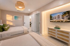 A hotel room with two beds, a television on the wall, and a view of the hotel exterior. - Your Own Private Luxe Resort – 12 Mins to Beach! (West Palm Beach)