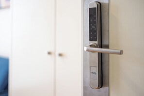 A door with a modern electronic lock and a handle.