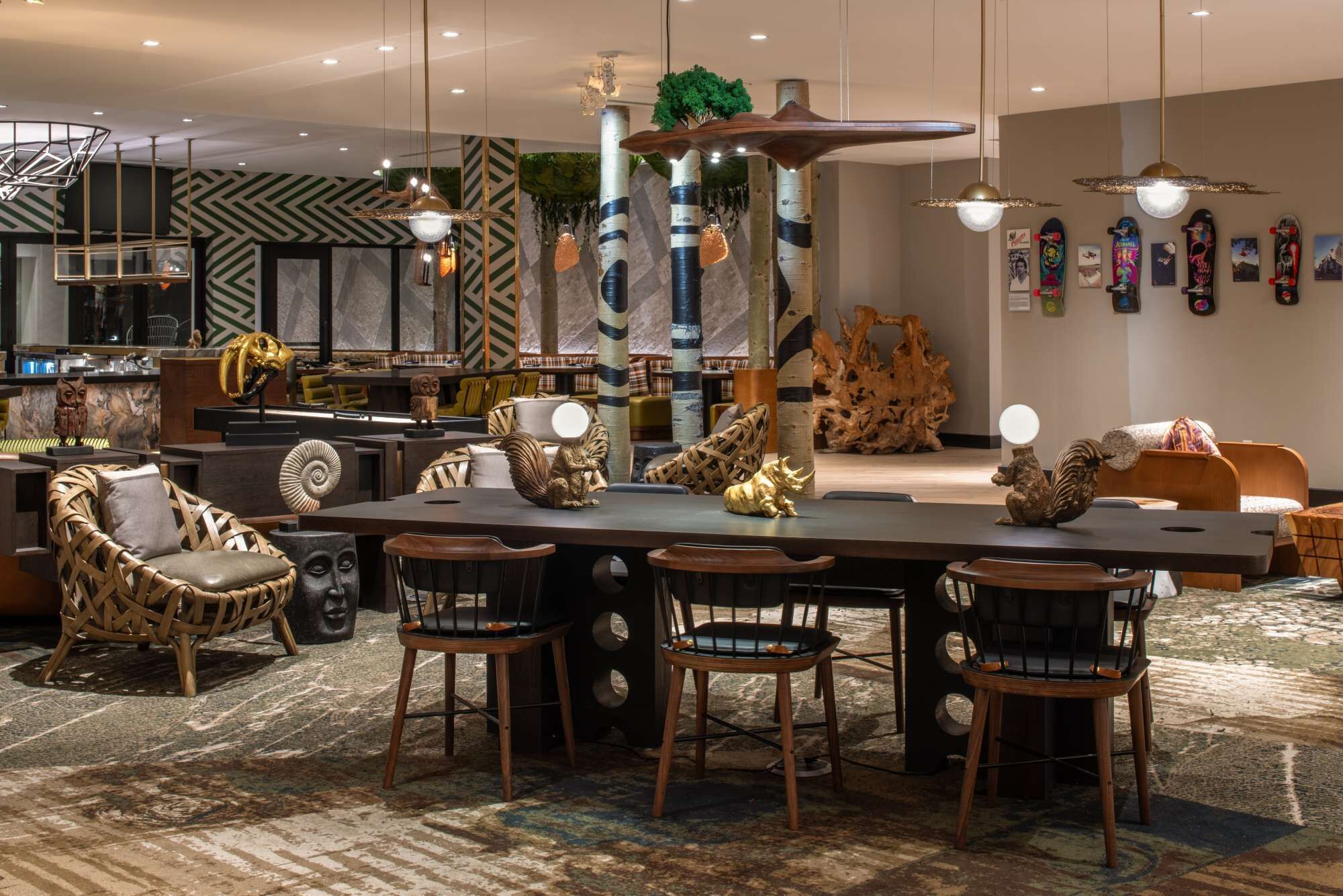 A modern dining area with a central table, surrounded by chairs, and a bar area with a counter.