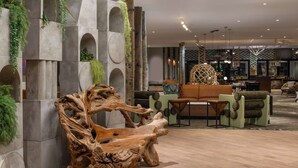 A modern interior with a unique wooden bench, green seating, and a patterned wall. - Iconic Nature Views | Monterey Bay. Pool (Santa Cruz)