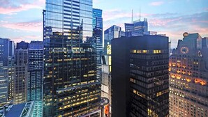 A cityscape with modern high-rise buildings, some with reflective glass facades.