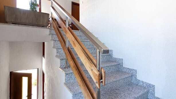 A staircase with wooden steps and metal handrails, leading to an upper floor. - Apartman FLORIS with AC and WIFI (Punat)