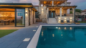 A modern house with a pool, stone exterior, and a covered patio area. - Villa La Vrana Zadarvillas (Pakostane)