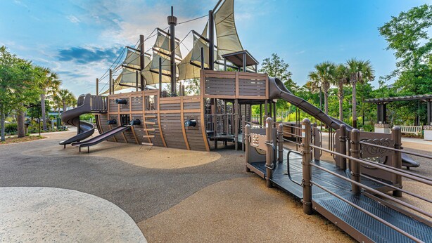 A playground with a slide, climbing structures, and a bridge. - 7 Ocean Gate Villas: 2 Bedroom South Forest Beach Villa (Hilton Head Island)