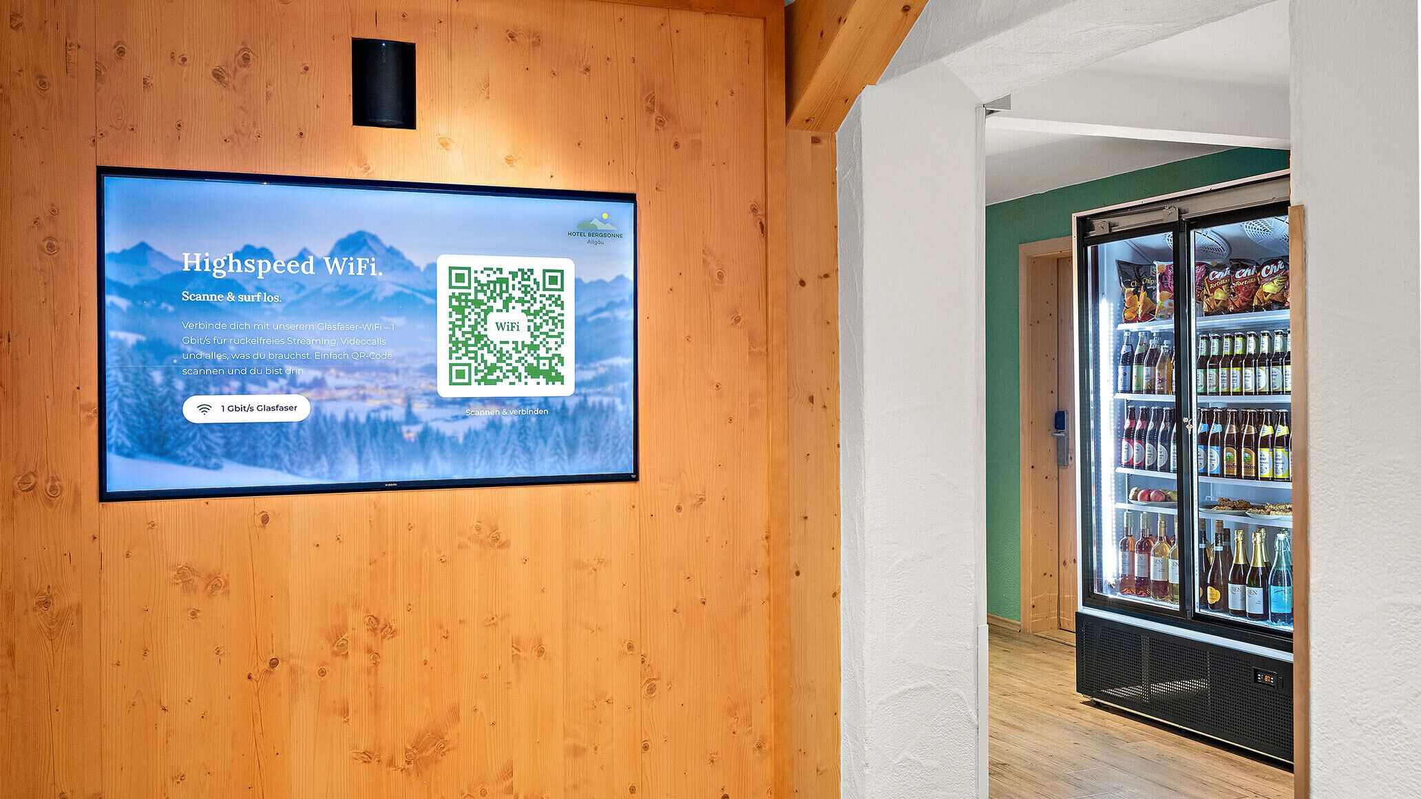 A digital display advertising high-speed WiFi with a QR code for easy access.
