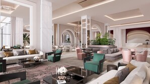 A spacious lobby with a modern design, featuring a seating area with sofas and armchairs, a coffee table, and a large potted plant. - Sinnada Resort & Thermaland (Afyonkarahisar)