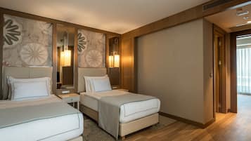 A hotel room with two beds, a large mirror, and a view of the outside.