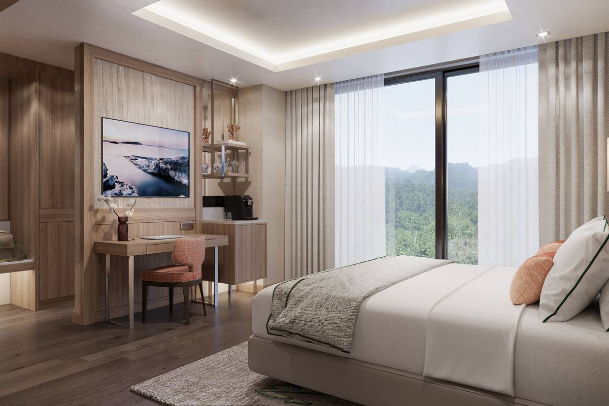 Une chambre d’hôtel moderne dotée d’un grand lit, d’un bureau avec une chaise, d’une machine à café et d’une grande fenêtre offrant une vue dégagée.