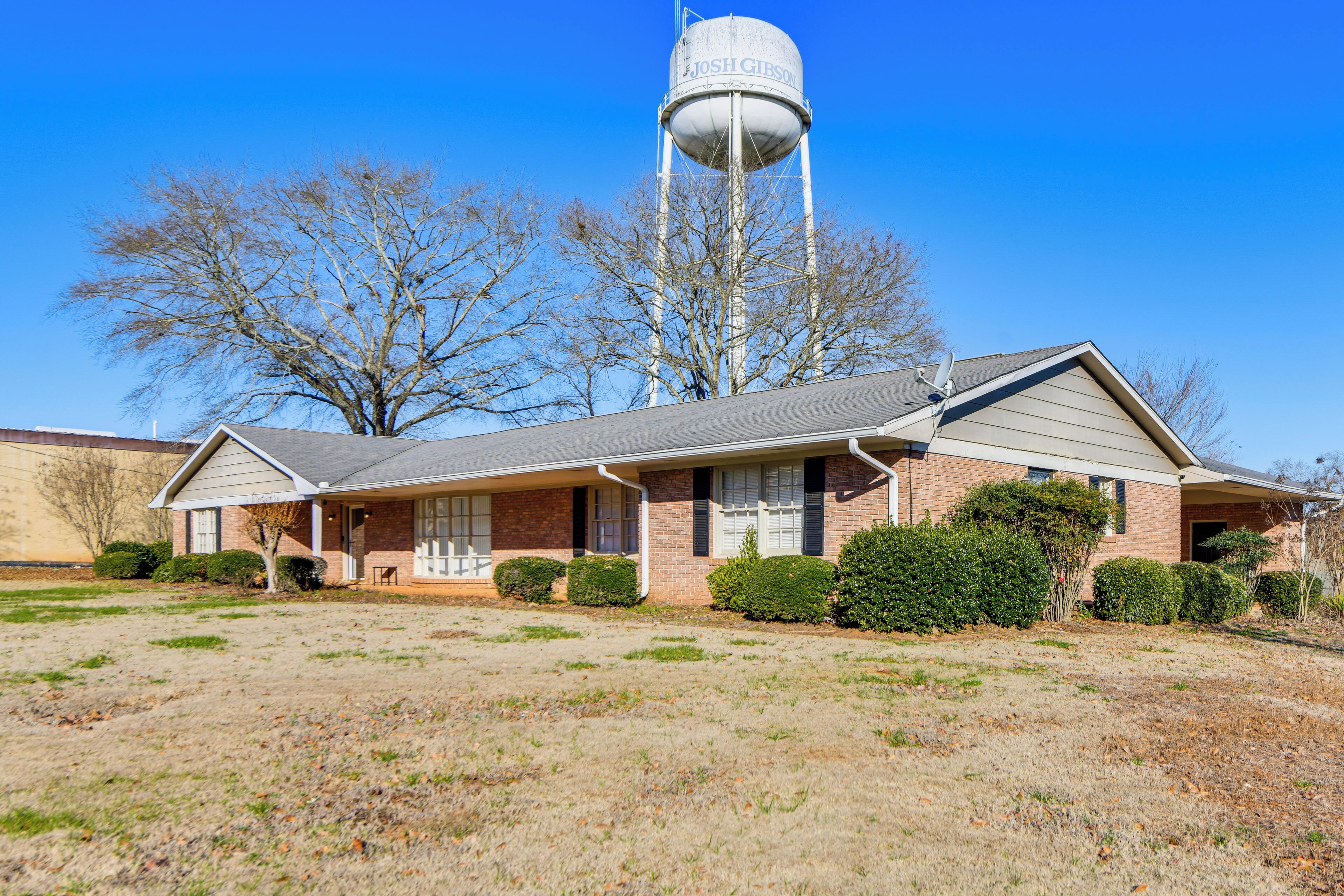 A two-story building with a water tower labeled 'JOSH GIBSON' in the background.