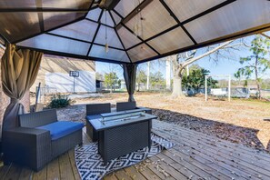 An outdoor patio with a covered seating area, a table, and a view of the surrounding landscape. - Walk to Town Square! Georgia Small-town Getaway (Buena Vista)