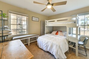 A bedroom with a bunk bed, a desk, a chair, a bench, and a ceiling fan. - Walk to Town Square! Georgia Small-town Getaway (Buena Vista)