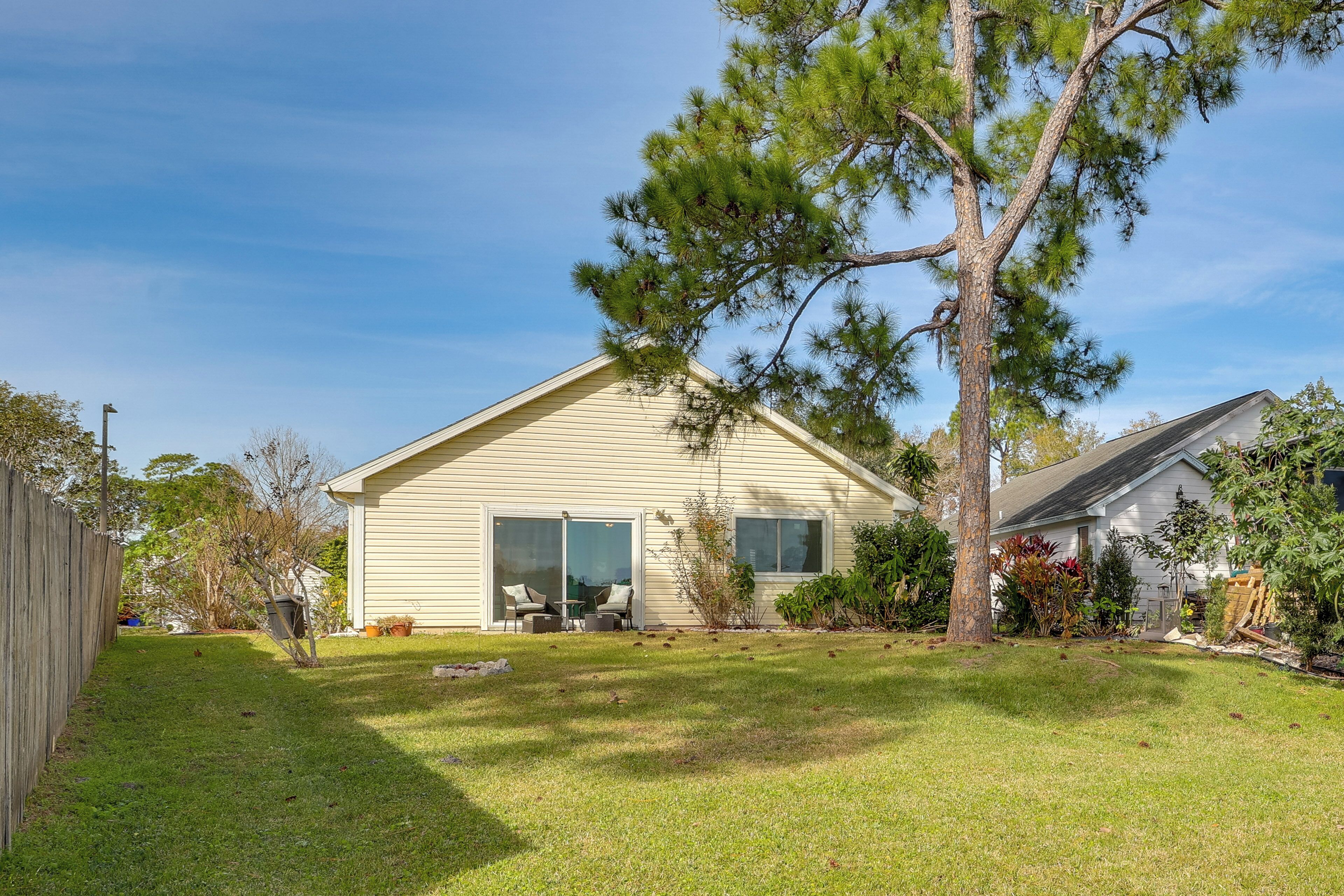 A single-story house with a covered patio and a lawn.