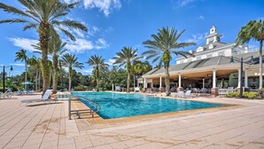 A swimming pool with lounge chairs and palm trees. - Reunion Resort: Brand-new Home Near Disney! (Kissimmee)