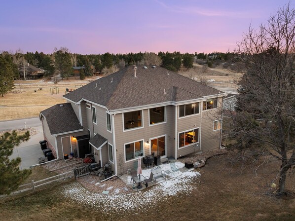 A multi-story house with a sloped roof, large windows, and a covered patio area. - New Listing! Pinery Lakeshore Retreat | Near Park (Parker)