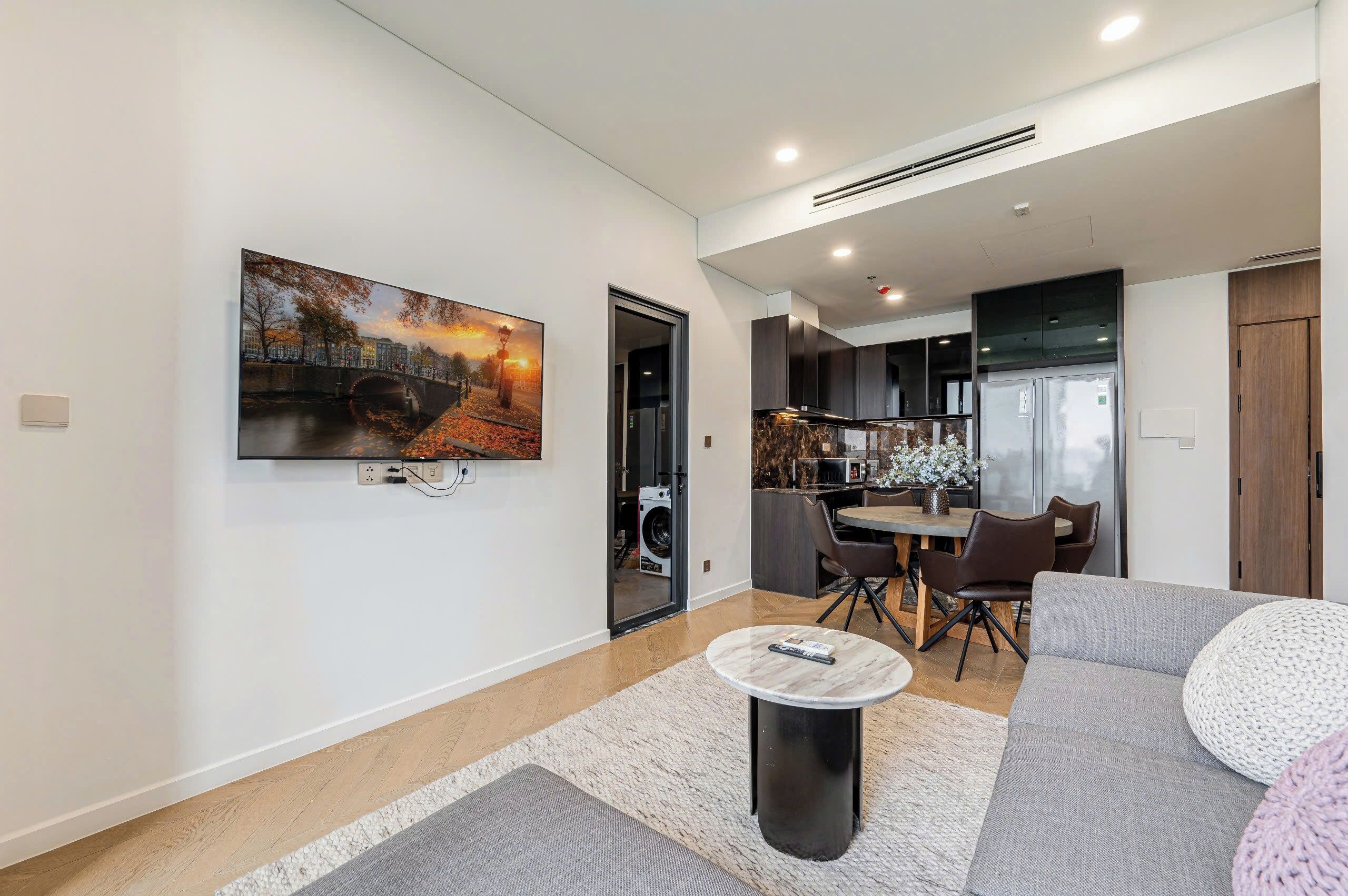 A modern living room with a sofa, a coffee table, and a painting on the wall.