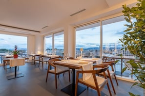 Dining - Modern, tastefully furnished hotel room of approximately 28 square meters, featuring a double bed and a single bed, a bathroom with a bathtub or shower, and a large balcony furnished with a table and chairs.Use of the pool and gymUnlimited access to the  (Olbia)
