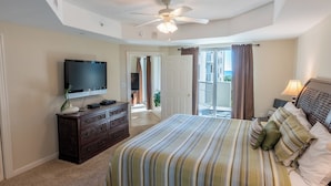 A bedroom with a bed, a television, a dresser, and a ceiling fan. - Ocean View 3BR Condo – Unit 208 Royale Palms (Myrtle Beach)