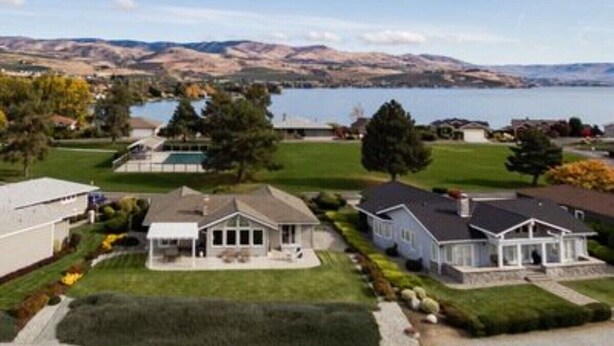 A residential area with houses, a lake, and hills in the background. - Welcome to Wapato Point, Manson, WA (Manson)