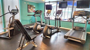A gym with various exercise equipment including treadmills, elliptical machines, and a bench press. - Welcome to Wapato Point, Manson, WA (Manson)