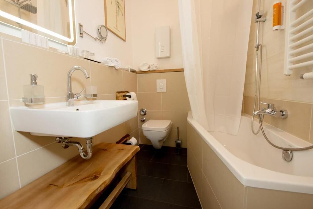 A bathroom with a sink, toilet, and bathtub.