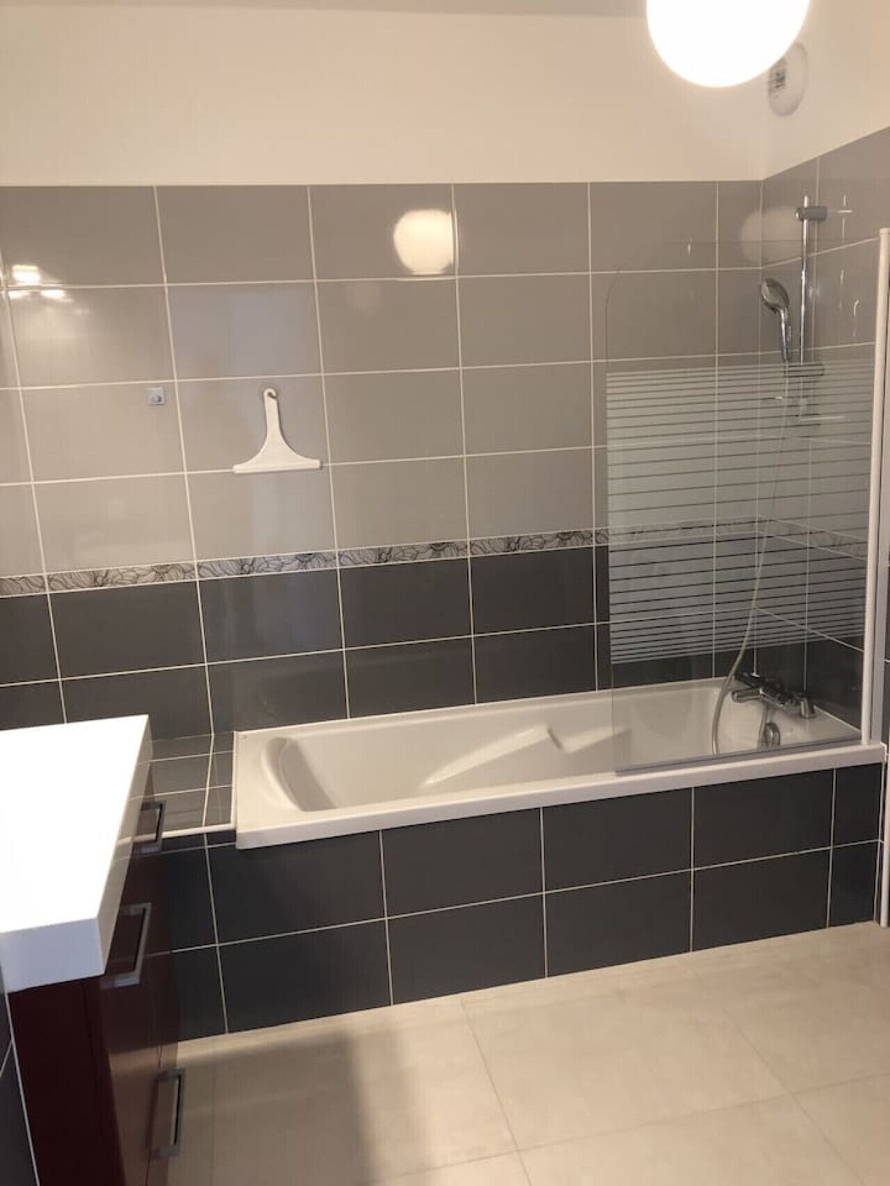 A modern bathroom with a bathtub, a shower, and a vanity with a mirror.