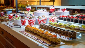 En buffet med forskellige desserter og kager.