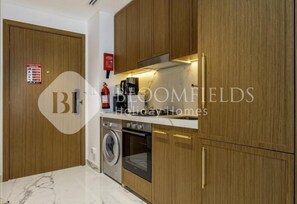 Apartment, Balcony, City View | Private kitchen - Bloomfields Comfortable Stu Azizi (Dubai)