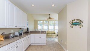 A kitchen with white cabinets, a countertop with appliances, and a ceiling fan. - Minutes from Fenwick Island & North Ocean City Beaches, Pelicans Perch a 3 bed, 2.5 bath Beautiful Home with Community Pool & Free WIFI (Selbyville)