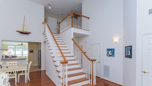 A staircase with wooden railings and white walls, leading to an upper floor. - Minutes from Fenwick Island & North Ocean City Beaches, Pelicans Perch a 3 bed, 2.5 bath Beautiful Home with Community Pool & Free WIFI (Selbyville)