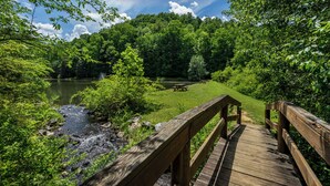 A wooden deck leading to a picnic area with a lake and forested hills in the background. - Welcome to Pine and Buck Lodge, a perfect 3 bedroom 2.5 bathroom get away (Ellijay)