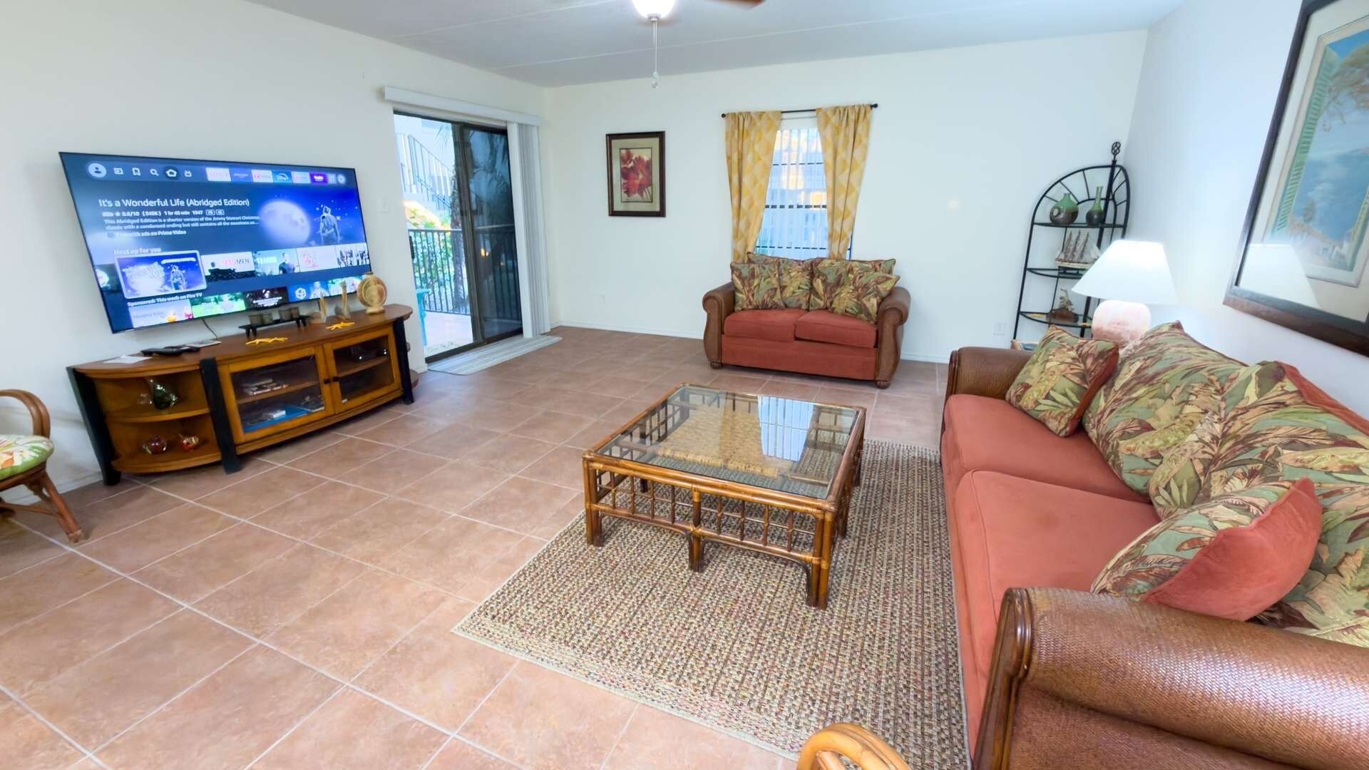 A living room with a television, sofa, and coffee table.
