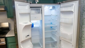 An open refrigerator with multiple shelves and a water dispenser. - Renovated 1st Floor Beach 250ft Pool 2 Bedroom Apts (South Padre Island)