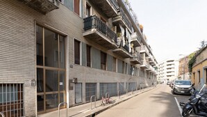 A multi-story building with balconies, a bicycle parked on the sidewalk, and a car parked on the street. - GuestHost - A comfortable 30 square meters studio, perfect for two people, located on the first floor of a building with an elevator (NOT suitable for people with reduced mobility).The apartment is just steps from Pasteur metro station and within a 10-mi (Milan)