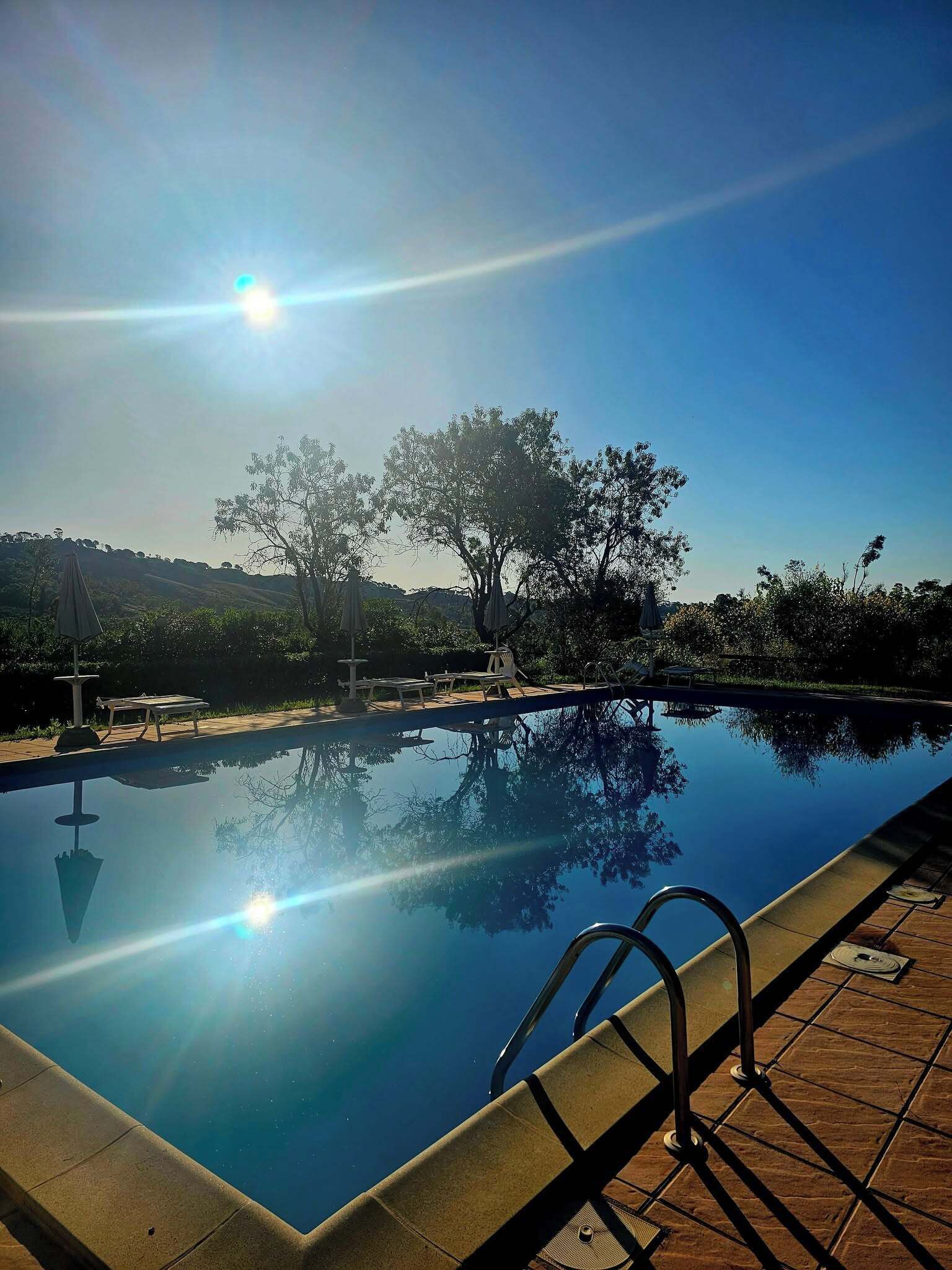 Seasonal outdoor pool, pool umbrellas, pool loungers