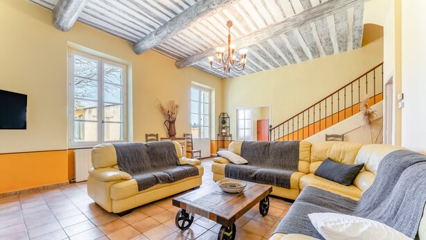 A living room with two sofas, a coffee table, a chandelier, and a staircase. - Château Mazane – Mas in the Heart of Vineyards, Pool and Mountain View (Sarrians)