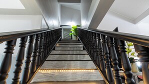 Eine Treppe mit Holzspindeln und einer Steinwand.