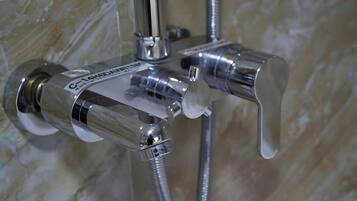 Combined shower/bathtub, designer toiletries, hair dryer, bathrobes